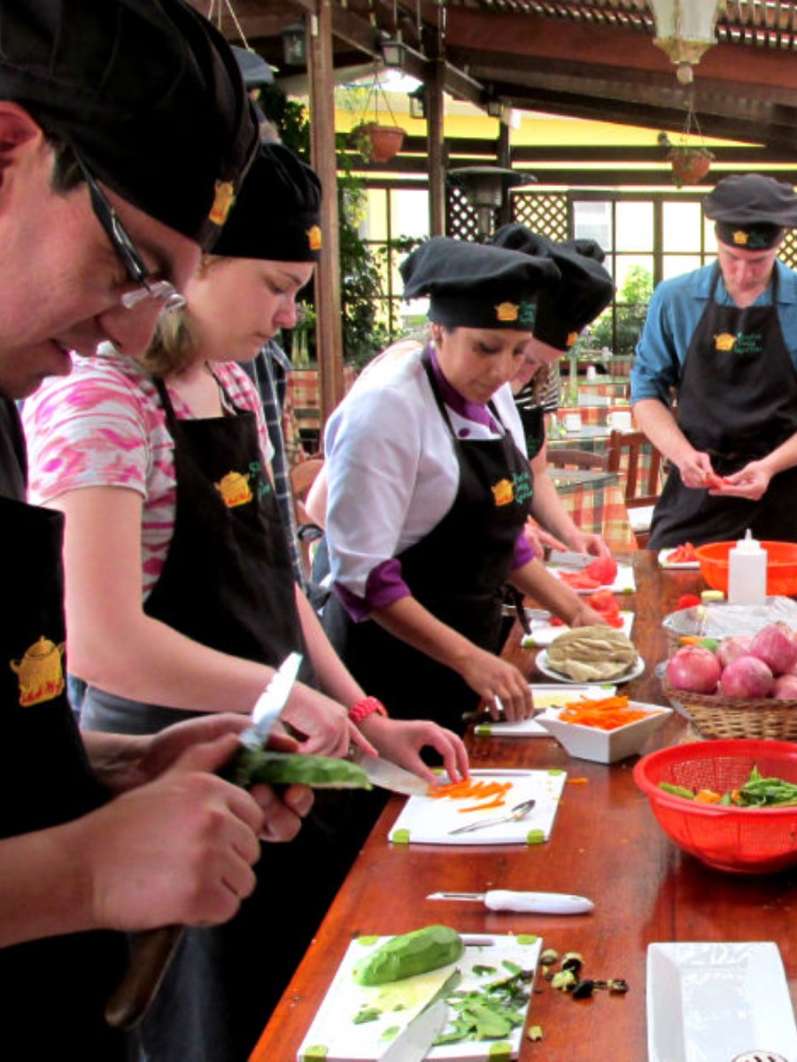 Guests participating in a Peruvian cooking class at Casa de Avila Hotel