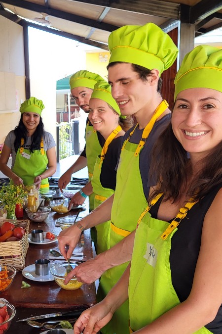 Travelers meeting during a shared cooking experience in Peru